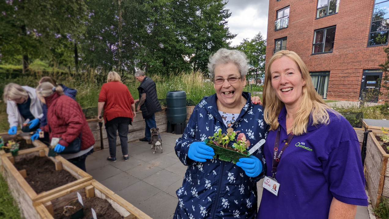 Photo of two people in a communal garden