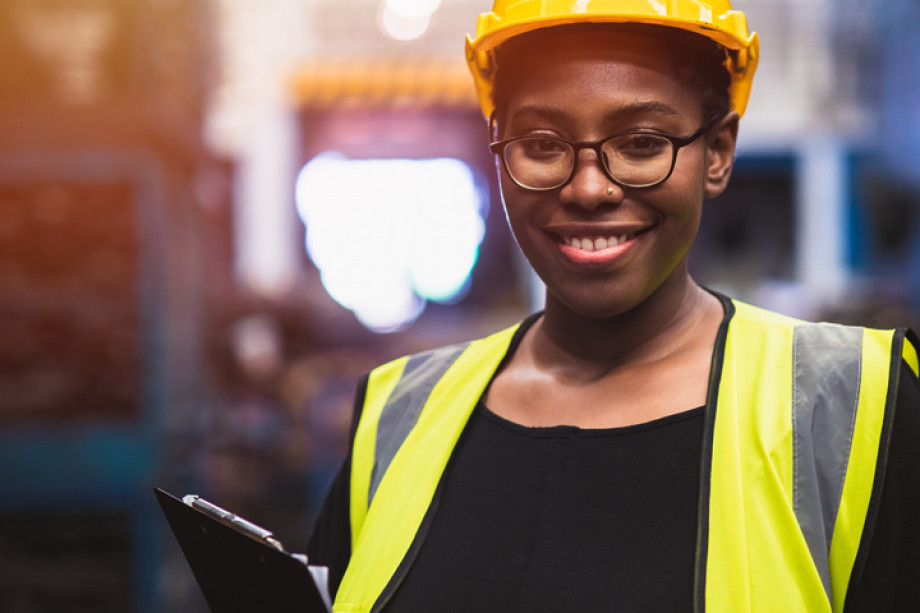 Photo of a person in a high visibility jacket in a warehouse